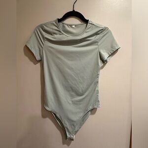 Light green/aqua short sleeve body suit.